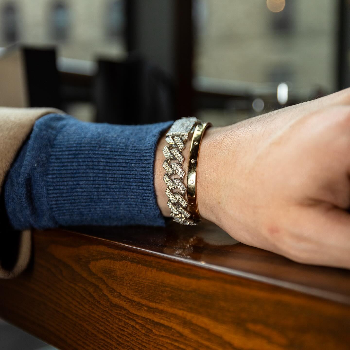 Diamond cuban link and gold cuff stacked on a tailored cuff